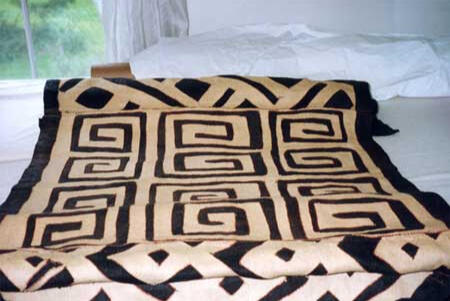 An African textile being prepared for hanging.